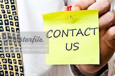 Contact us post it in business man hand