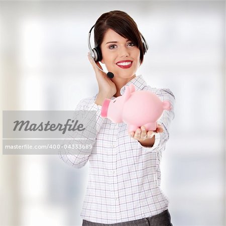 Young business woman with headset holding piggy bank