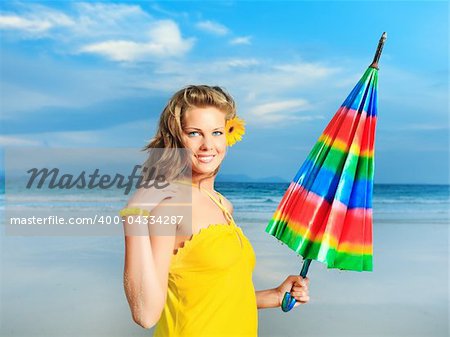 Beautiful woman in yellow dress with umbrella