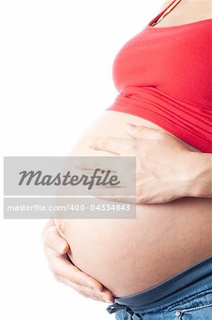 Pregnant woman holding her belly with hands over white background