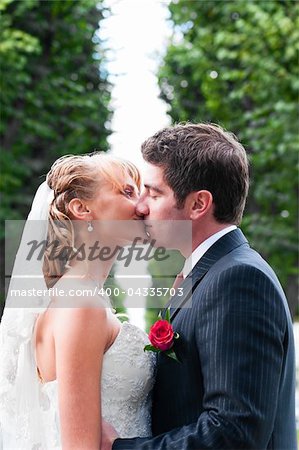 just married couple is kissing at park