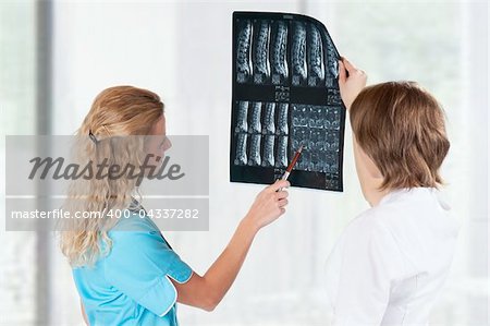 Medical doctors analysing x-ray photography in hospital