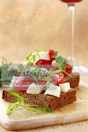sandwich with mozzarella and tomatoes on rye bread of Italian style