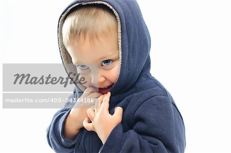 portrait of little boy in big fur hood looking at camera