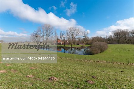 farm house with pond behind the river dike. These ponds are usually the result of earlier dike breaches.