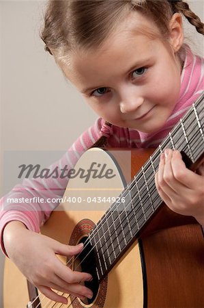 Young girl play classical guitar