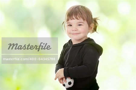 Portrait of a 2 year old girl against abstract green background