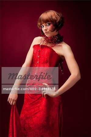 Beautiful girl in red dress over on red background