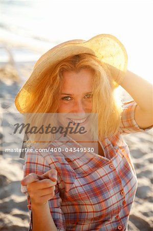 Portrait of beautiful blonde girl in cap. Outdoor photo.