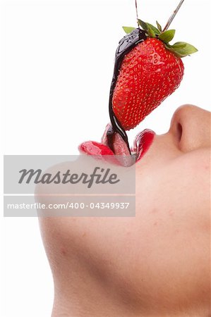 Beautiful girl eating a fresh red strawberry with chocolate sauce