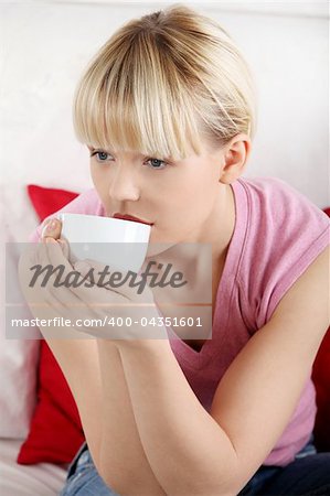 Young beautiful woman having coffee or tea