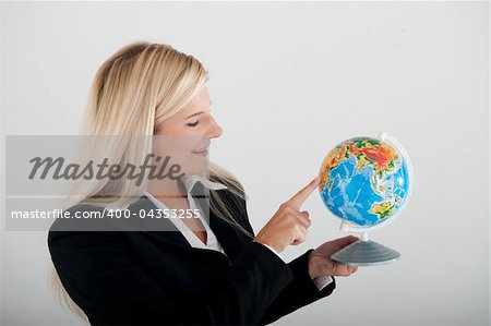 Beautiful business woman in a suit with globe figure