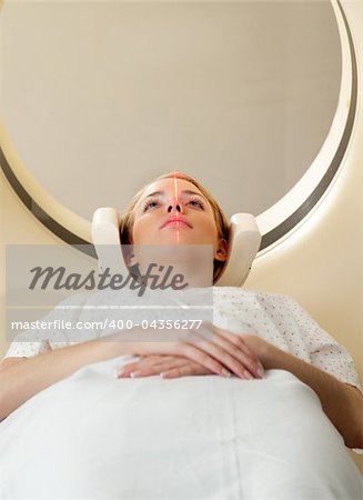 A woman having a CT scan taken - laser is on and ready