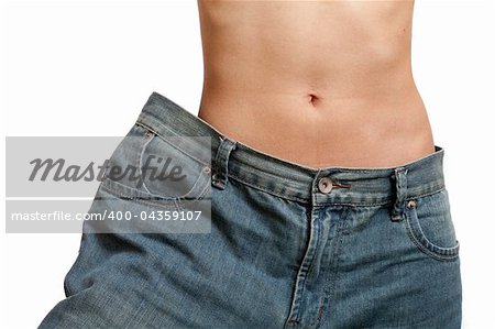Young woman wearing her old jeans, showing her body after losing weight