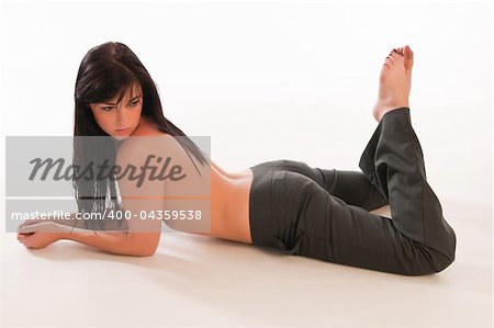 Pretty young long haired brunette topless in slacks