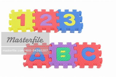 Colorful puzzle blocks with 123 and ABC arranged on white background
