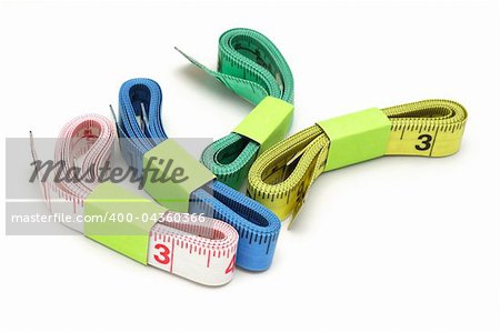 Four color measuring tapes on white background