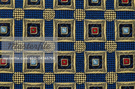 Abstract pattern ornamented textile closeup.