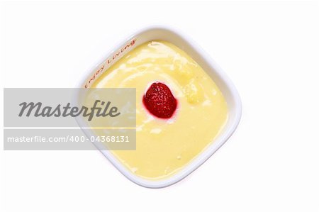 Custard with strawberries in a saucer isolated on white