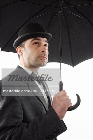 man with bowler hat and an umbrella