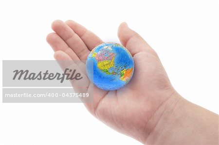 Globe in young boy's hand on white background