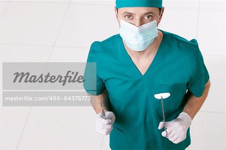 Surgeon in mask and gloves with the tools