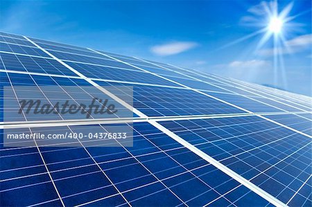 Closeup of Solar Panels with sunlight and blue sky background