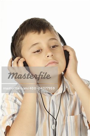 Boy with headphones listening to music over white