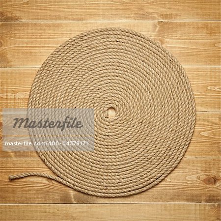 Twisted rope on wooden background