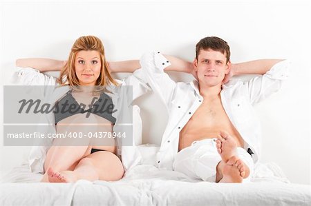 man and his pregnant wife in bed at morning
