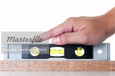A hand measures the balance with measurement tools on wood isolate with white background.