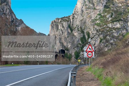 Dangerous Curves Sign at the Road Running Along the Railway in the Pyrenees