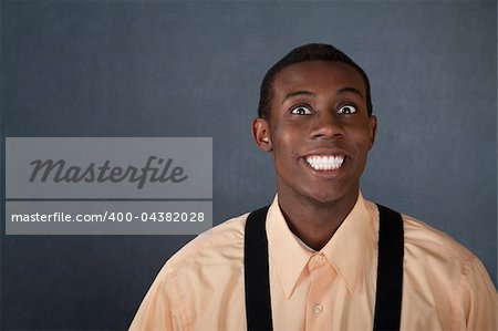 Happy young Black man on gray background with big grin