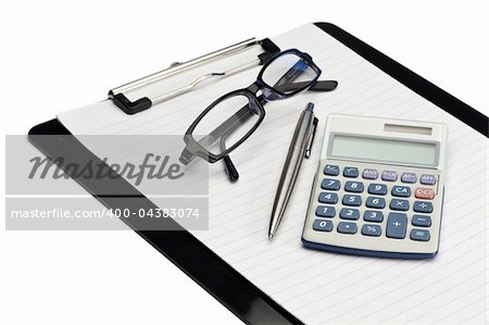 Angled note pad, pen, glasses and pocket calculator on a white background