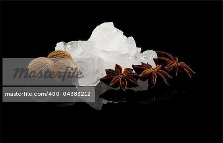 crystal sugar and spice  over black reflective surface background