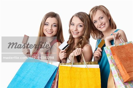 Attractive girls with bags and credit cards on a white background