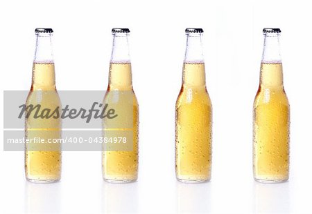 Bottles of beer with water drops isolated on white