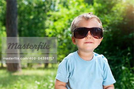 Cute 2 years old boy Sunglasses outdoors at sunny summer day