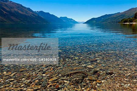 View of the clear waters and mountains at lake Wakatipu, New Zealand