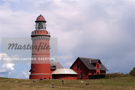 Danish red lighthouse from Bovbjerg. Close-up buildings in summer sun.