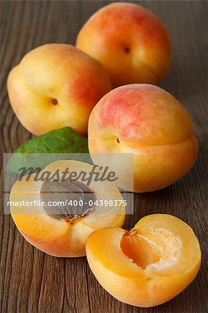 Fresh apricot with leaf  on a wooden board.