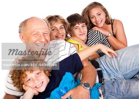 Happy family having fun together lying in studio, posing...