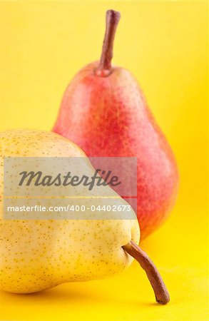 Yellow and red pears on yellow background
