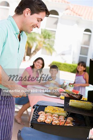 Family Enjoying A Barbeque