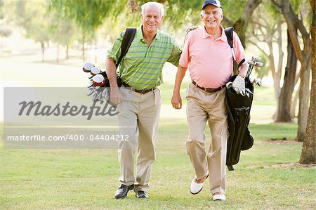 Male Friends Enjoying A Game Of Golf