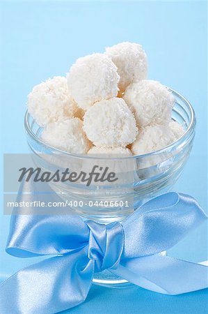 Homemade coconut candies in a bowl with a bow