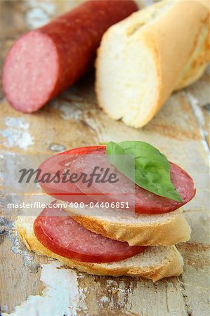 Sandwiches with baguette and salami with cheese and tomatoes