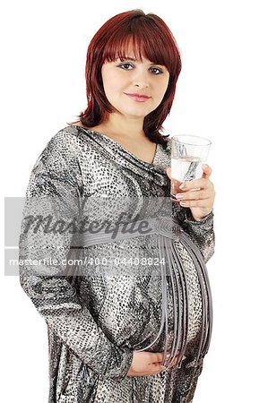 Pregnant woman holds the glass of the water