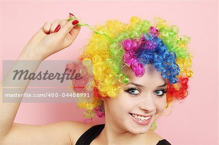 Young beautiful woman in the wig of the clown