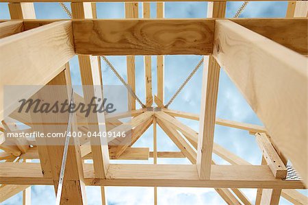 New residential construction home framing against a blue sky.Shallow focus.